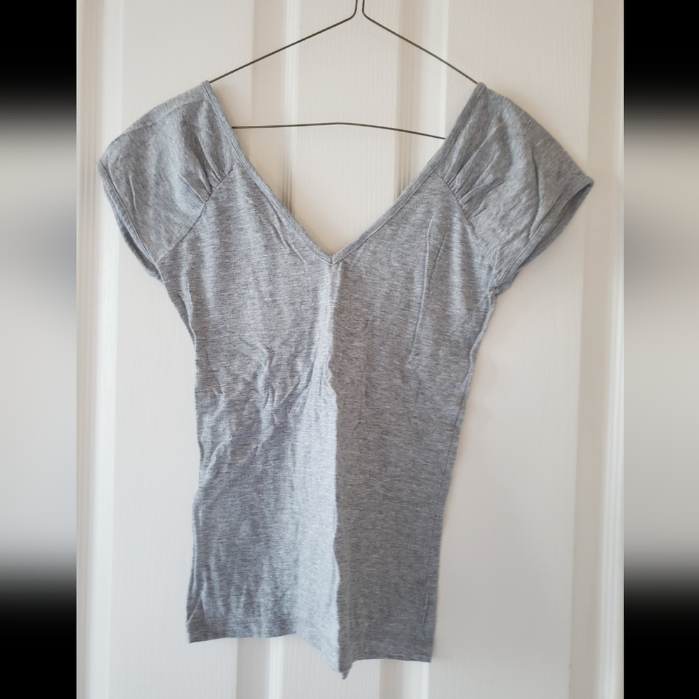 A light gray short sleeved tshirt with light silver stripes.